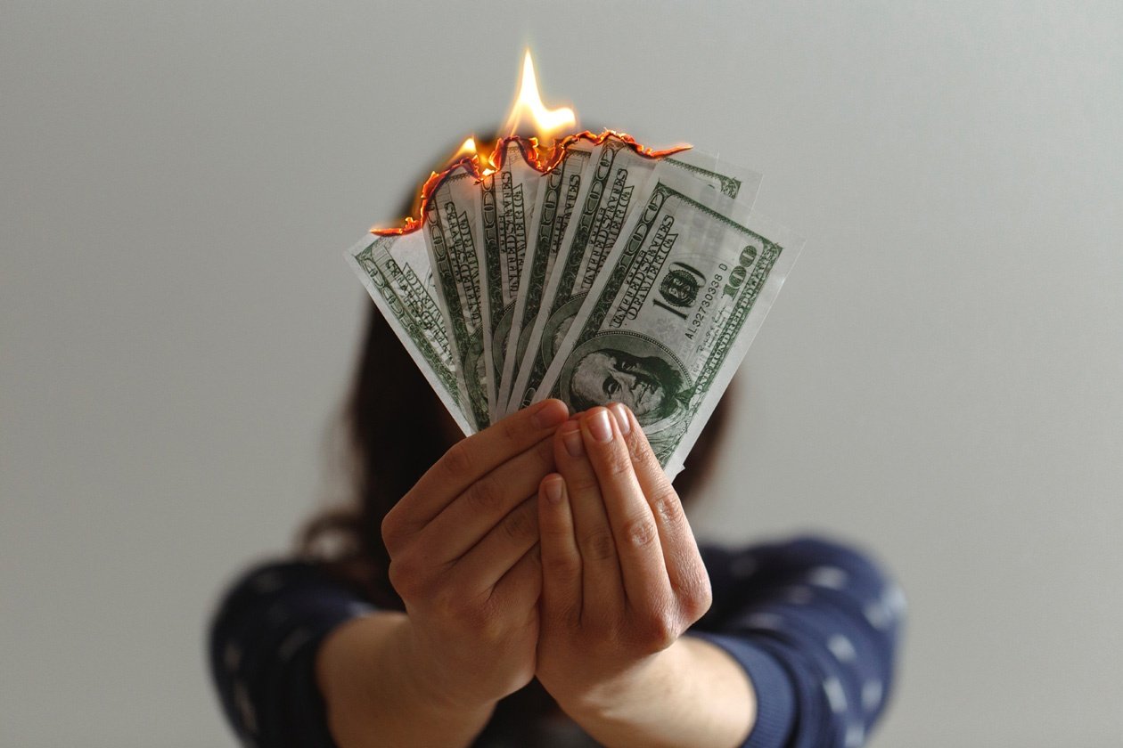 Lady Burning Money - Save Money on Heating Bills