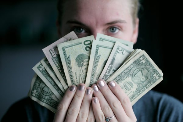 Lady Holding Money she saved from heating bills